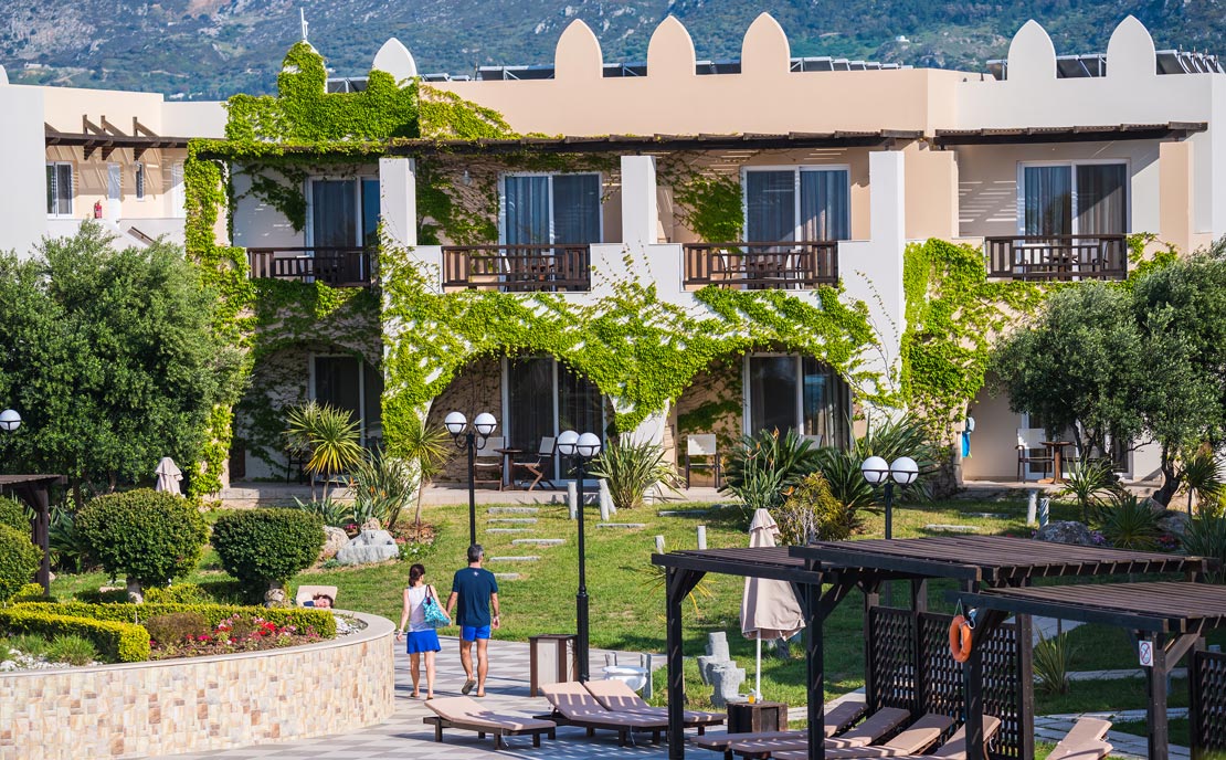 Buildings in garden at Gaia Palace Hotel